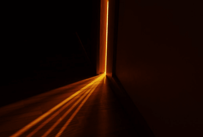 Light entering a room through narrow slit of slightly opened door